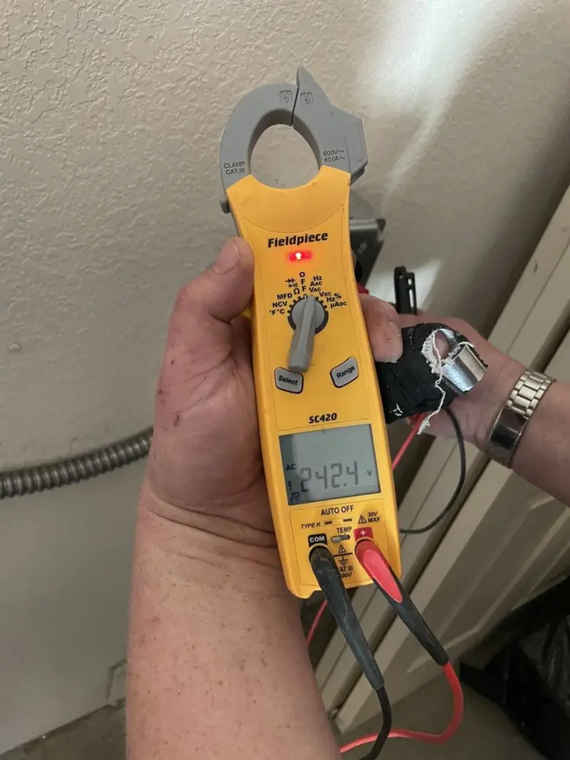 Voltage testing with clamp meter during Ceiling Fan Installation in Lowell